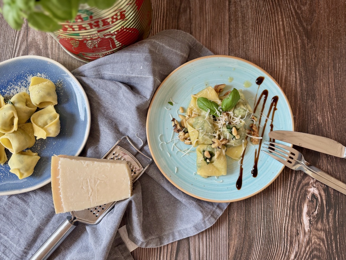 Tortellini mit Spinat-Ricotta_Füllung angerichtet mit Pinienkernen und zerlassener butter
